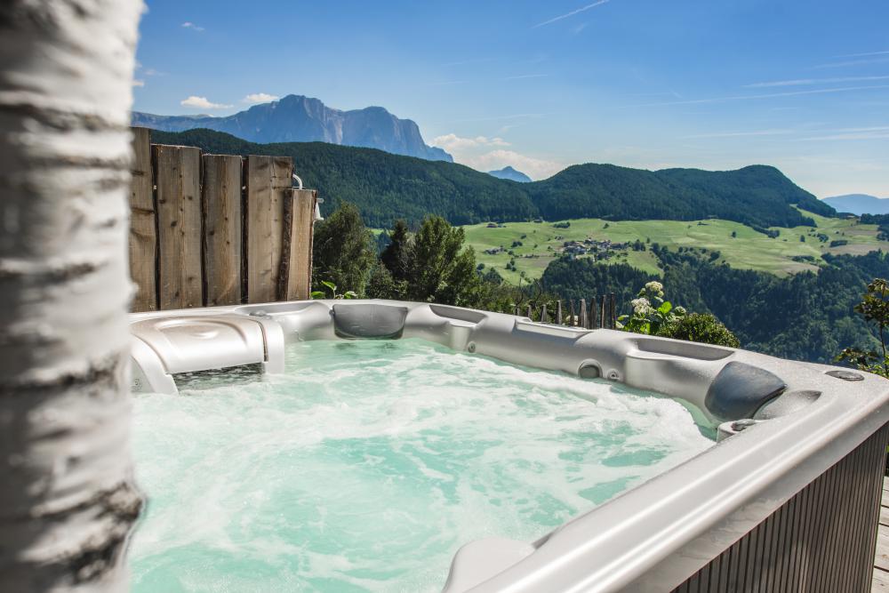 Year-round heated hot tub on the fenced terrace