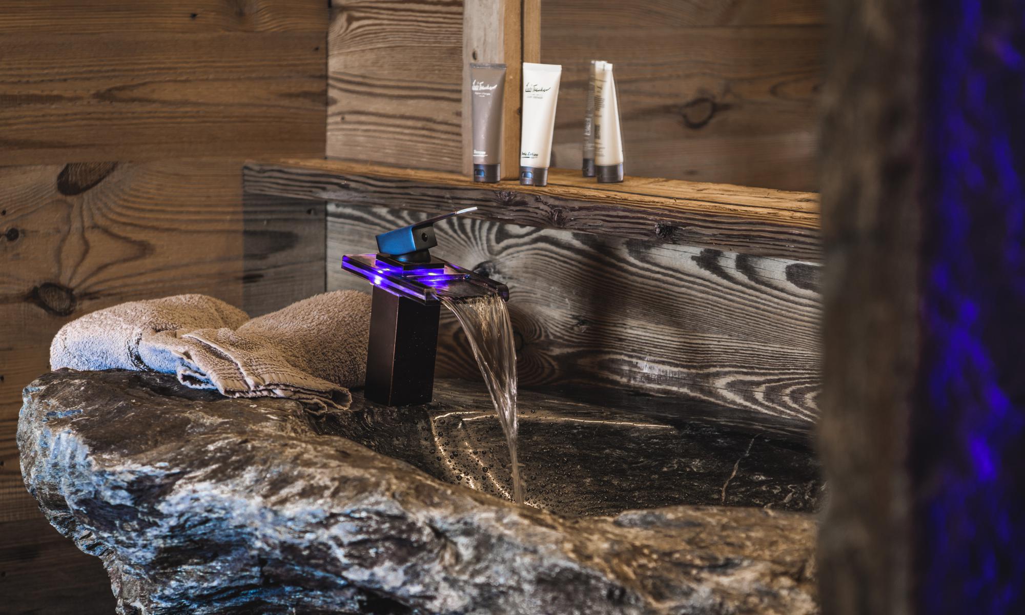 Bath with deluxe shower as well as washbasin made from stone found on our property